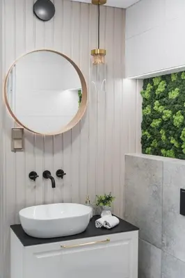 a bathroom with a sink and a mirror at Old Town view Apartment in city center in Anykščiai