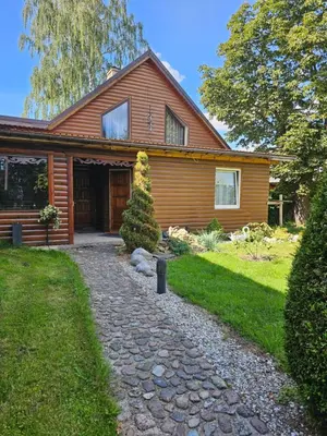 a house with a stone path in front of it at Svečiu Namai in Pagiriai