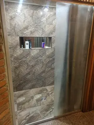 a shower with a stainless steel door in a bathroom at Svečiu Namai in Pagiriai
