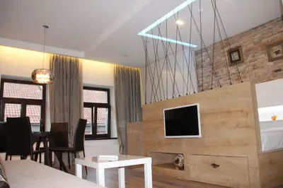 a living room with a tv and a table at Angel Wing Apartamentai in Vilnius