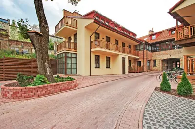 an empty street in front of a building at Angel Wing Apartamentai in Vilnius