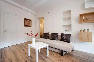 a living room with a couch and a table at Angel Wing Apartamentai in Vilnius