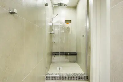 a shower stall with a glass door in a bathroom at Angel Wing Apartamentai in Vilnius