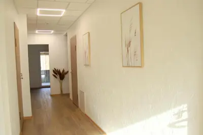 a hallway with two pictures on the walls of a building at Pakalnės sodyba in Skverbai