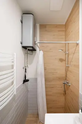 a bathroom with a shower with a shower curtain at Cozy studio in the city center in Vilnius