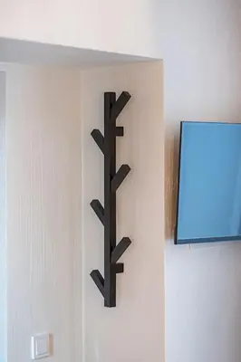 a black metal object hanging on a wall at Cozy studio in the city center in Vilnius