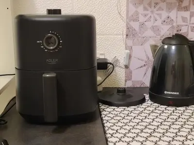 a slow cooker and a tea kettle on a counter at Tiny center G studio in Kaunas