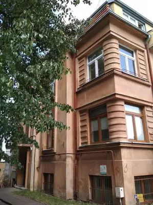 a brown building with windows on the side of it at Tiny center G studio in Kaunas