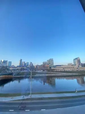 a view of a river with a city in the background at Cathedral Apartment FREE Parking in Vilnius