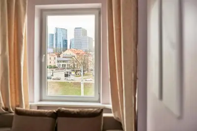 a window with a view of a city at Cathedral Apartment FREE Parking in Vilnius