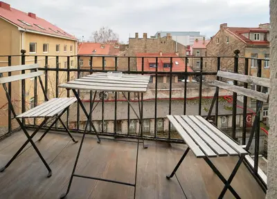 a table and two chairs on a balcony at Cathedral Apartment FREE Parking in Vilnius