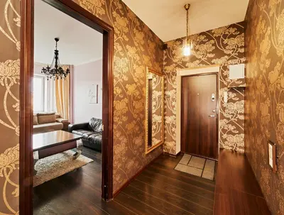 a hallway with a living room with wallpaper at Cathedral Apartment FREE Parking in Vilnius