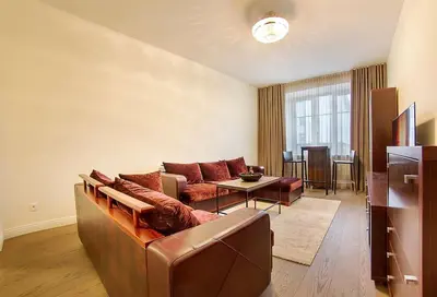 a living room with a couch and a table at Butas Šiaulių mieste in Šiauliai
