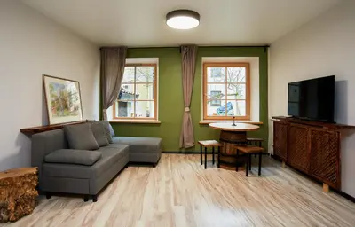 a living room with a couch and a tv at Town Hall Apart in Vilnius