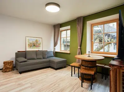 a living room with a couch and a table at Town Hall Apart in Vilnius