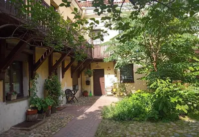 a courtyard of a house with trees and a walkway at Town Hall Apart in Vilnius