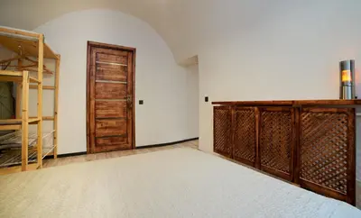 an empty room with a closet and a wooden door at Town Hall Apart in Vilnius