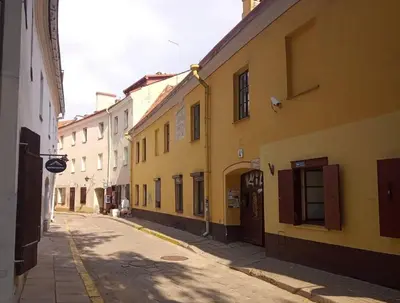an empty street in an alley with buildings at Town Hall Apart in Vilnius