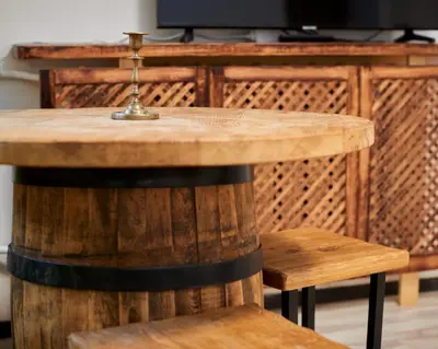 a wooden table and two chairs and a table and a television at Town Hall Apart in Vilnius