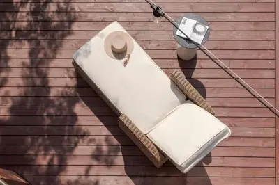 a white bench on the side of a house at 252 m² luxury 4 bedroom house in the pine-forest in Vilnius