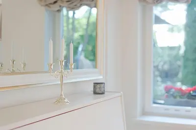 a candle holder on a window sill with two candles at 252 m² luxury 4 bedroom house in the pine-forest in Vilnius