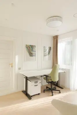 an office with a desk and a green chair at 252 m² luxury 4 bedroom house in the pine-forest in Vilnius
