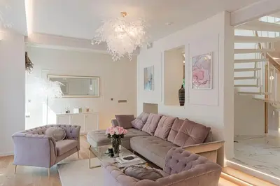 a living room with a couch and a table at 252 m² luxury 4 bedroom house in the pine-forest in Vilnius