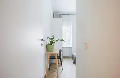 a room with a table and a potted plant at Kurpiai Old Town, 3BD in Kaunas