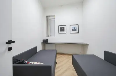 a living room with two couches and a table at Kurpiai Old Town, 3BD in Kaunas