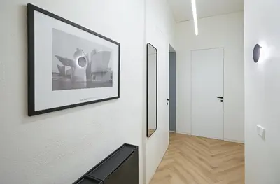 a hallway with a picture of the sydney opera house at Kurpiai Old Town, 3BD in Kaunas