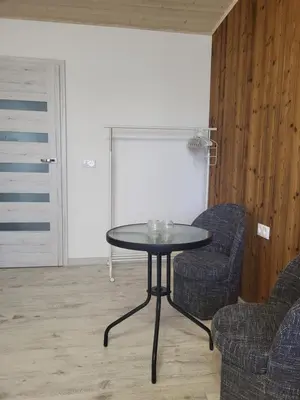 a table and two chairs in a living room at Poilsis dviems in Šiauliai
