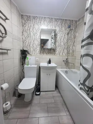 a bathroom with a toilet and a sink and a tub at Poilsis dviems in Šiauliai