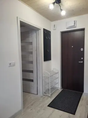 an empty room with a door and a closet at Poilsis dviems in Šiauliai