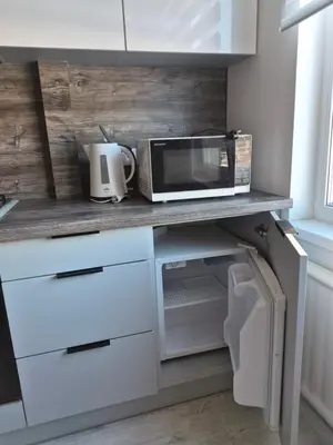 a kitchen counter with a microwave and a toaster oven at Poilsis dviems in Šiauliai
