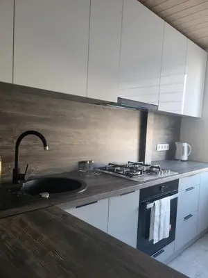 a kitchen with a sink and a stove at Poilsis dviems in Šiauliai