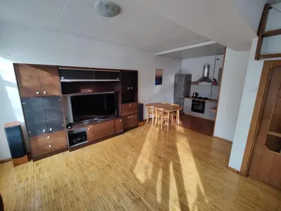 a living room with a large entertainment center and a wooden floor at Spacious apartment near old town in Vilnius