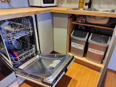 a dishwasher with a sink in it in a kitchen at Spacious apartment near old town in Vilnius