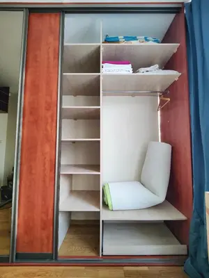 an open closet with a chair and shelves at Spacious apartment near old town in Vilnius