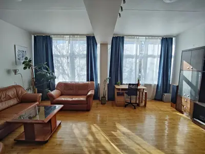 a living room with a couch and a table at Spacious apartment near old town in Vilnius