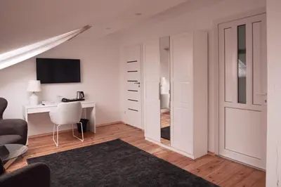 a white room with a desk and a computer in it at Laurentroom Hotel in Ukmergė
