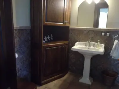 a bathroom with a sink and a mirror at Forest apartment in the loop of the river Neris in Verkšonys