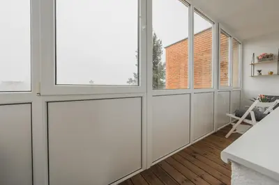 a room with white walls and windows at City Center Apartment with balcony in Anykščiai