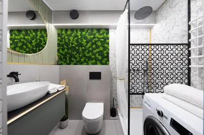 a bathroom with a sink and a washing machine at City Center Apartment with balcony in Anykščiai