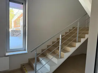 a staircase in a house with a window at Alytaus sporto viešbutis Self Check-in in Alytus