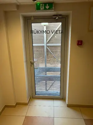 a door in a room with a sign on it at Alytaus sporto viešbutis Self Check-in in Alytus