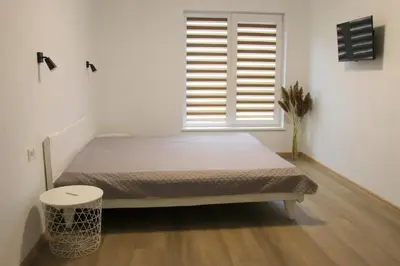 a bedroom with a bed in front of a window at Pakalnės sodyba in Skverbai
