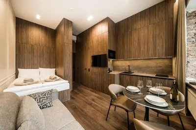 a hotel room with a bed and a table at Central Park Apartments - The Luxury Collection in Kaunas