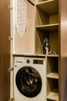 a laundry room with a washer and dryer at Central Park Apartments - The Luxury Collection in Kaunas