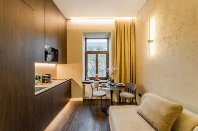 a small room with a table and a kitchen at Central Park Apartments - The Luxury Collection in Kaunas
