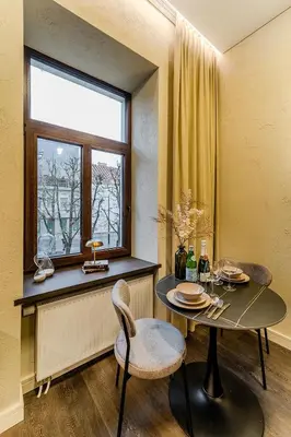 a dining room with a table and a window at Central Park Apartments - The Luxury Collection in Kaunas